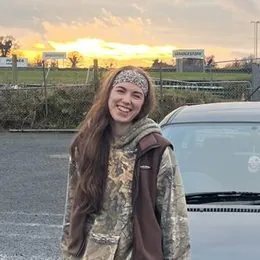 Jessie sitting on the bonnet of her black BMW